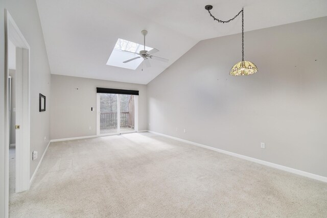 1972 Pine Ridge Dr, Manistee, MI 49660 - carpeted spare room featuring lofted ceiling, a skylight, baseboards, and a ceiling fan