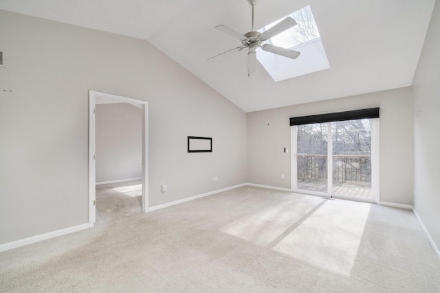 1972 Pine Ridge Dr, Manistee, MI 49660 - carpeted spare room featuring a ceiling fan, a skylight, vaulted ceiling, and baseboards