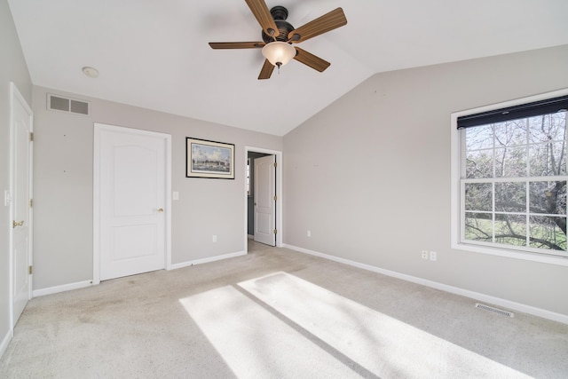 1972 Pine Ridge Dr, Manistee, MI 49660 - unfurnished bedroom featuring light carpet, lofted ceiling, baseboards, and ceiling fan