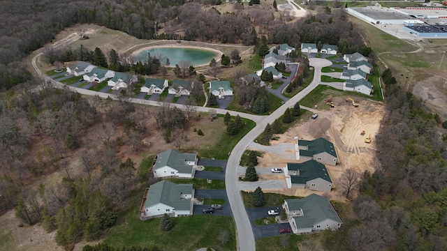 1972 Pine Ridge Dr, Manistee, MI 49660 - aerial view of property and surrounding area featuring nearby suburban area, a forest, and a large body of water