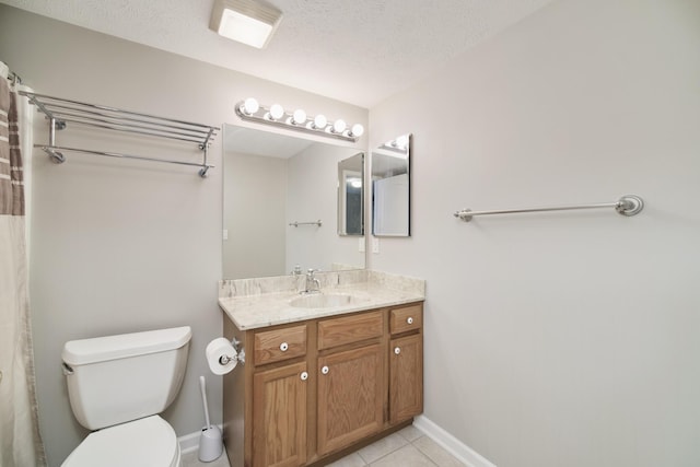 1972 Pine Ridge Dr, Manistee, MI 49660 - bathroom with toilet, baseboards, tile patterned flooring, vanity, and a textured ceiling