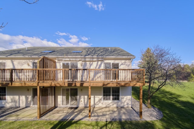 1972 Pine Ridge Dr, Manistee, MI 49660 - rear view of property with a patio, a lawn, and a deck
