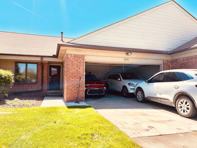 view of front facade featuring brick siding, an attached garage, concrete driveway, and a front yard