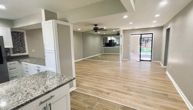 unfurnished living room featuring light wood-style floors, ceiling fan, recessed lighting, baseboards, and a fireplace