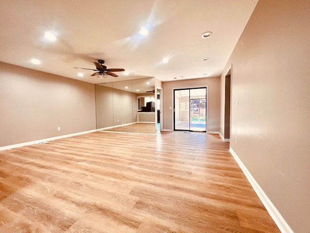 unfurnished living room featuring recessed lighting, a ceiling fan, light wood finished floors, and baseboards