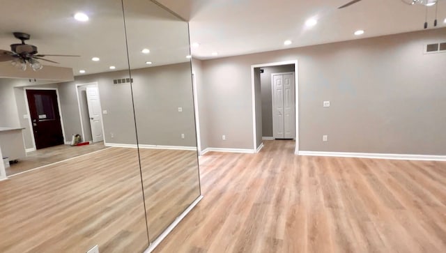 interior space featuring light wood-style flooring, baseboards, and recessed lighting