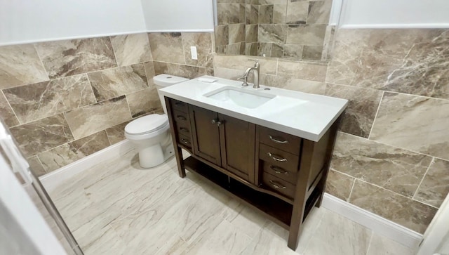 bathroom featuring tile walls, vanity, and toilet