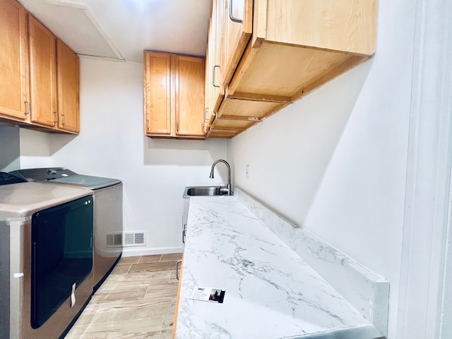 laundry area featuring cabinet space, washer and dryer, and baseboards