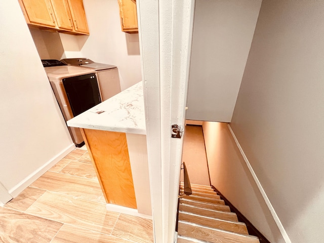 stairs featuring washing machine and dryer and baseboards