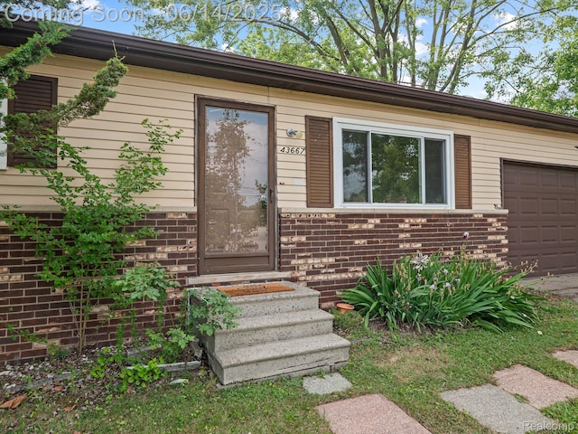 43667 Dequindre Rd, Troy, MI 48085 - view of exterior entry featuring brick siding and an attached garage