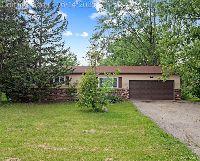 43667 Dequindre Rd, Troy, MI 48085 - ranch-style house with brick siding, a garage, driveway, and a front yard