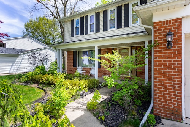 21964 Sunrise Blvd, Novi, MI 48375 - doorway to property featuring brick siding and a porch