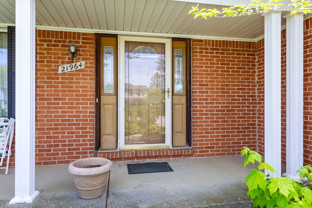 21964 Sunrise Blvd, Novi, MI 48375 - view of exterior entry with covered porch and brick siding
