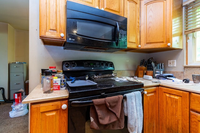 21964 Sunrise Blvd, Novi, MI 48375 - kitchen featuring black appliances, light countertops, carpet flooring, and brown cabinets
