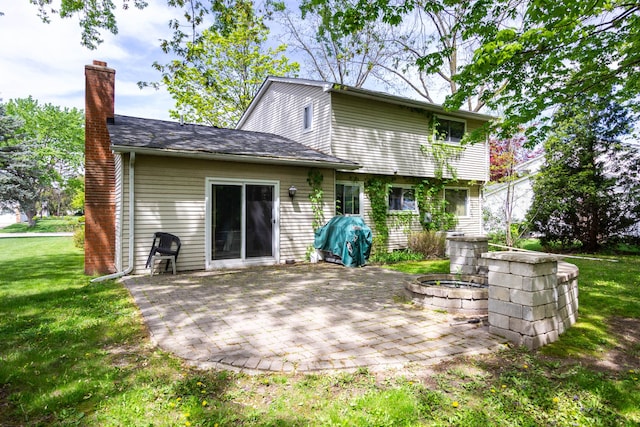 21964 Sunrise Blvd, Novi, MI 48375 - back of house with a chimney, a patio area, and a yard