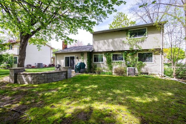 21964 Sunrise Blvd, Novi, MI 48375 - back of house with a lawn, central AC, a patio, and a chimney