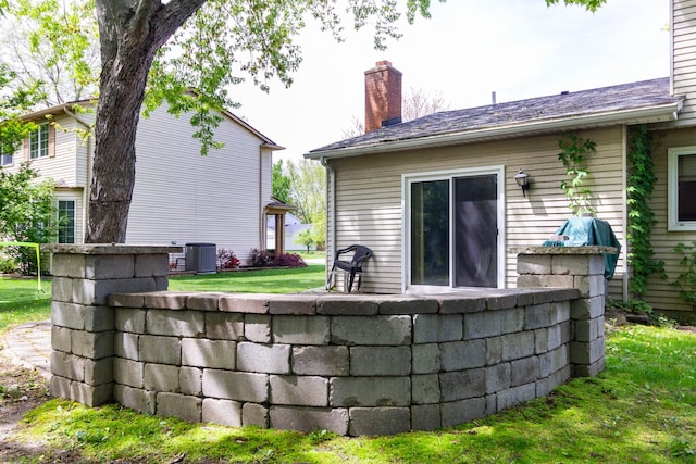 21964 Sunrise Blvd, Novi, MI 48375 - back of property featuring a chimney, a yard, and central air condition unit