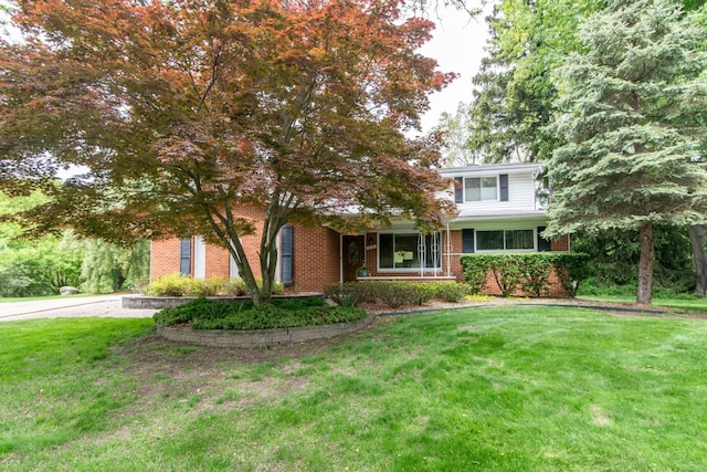 6279 Walker Ct, Troy, MI 48085 - view of property hidden behind natural elements with brick siding and a front lawn