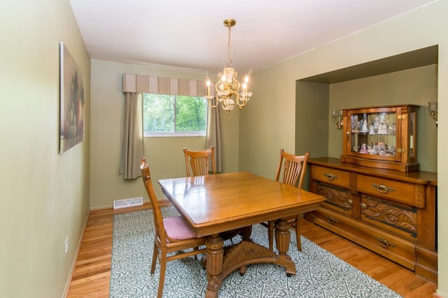 6279 Walker Ct, Troy, MI 48085 - dining area featuring a chandelier, light wood-type flooring, and baseboards