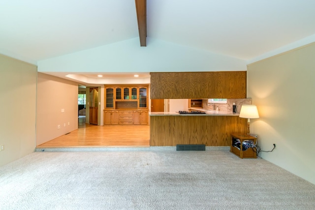 6279 Walker Ct, Troy, MI 48085 - kitchen featuring light colored carpet, a peninsula, brown cabinets, a sink, and recessed lighting