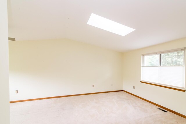 6279 Walker Ct, Troy, MI 48085 - empty room featuring a skylight, light carpet, baseboards, and lofted ceiling