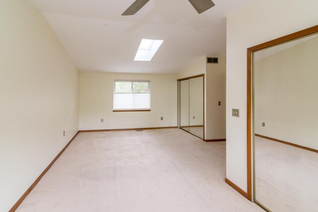 6279 Walker Ct, Troy, MI 48085 - carpeted spare room featuring a skylight, a ceiling fan, baseboards, and vaulted ceiling