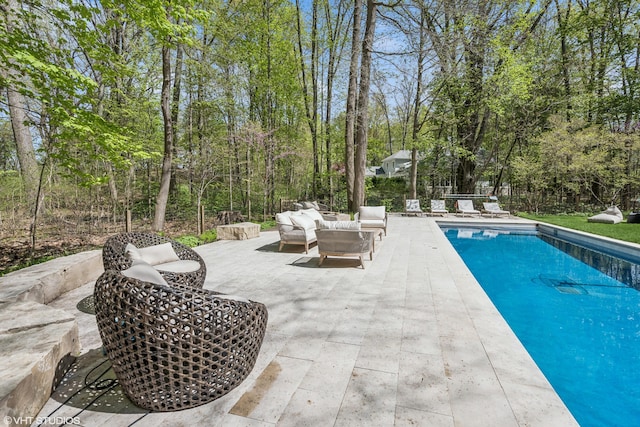 outdoor pool featuring an outdoor hangout area and a patio