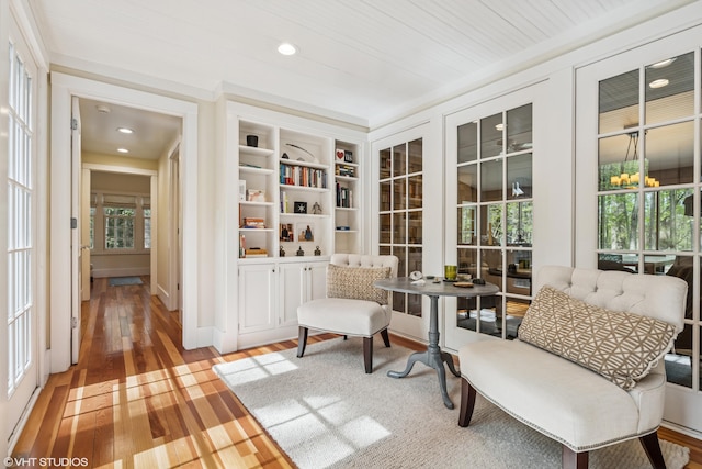 living area featuring wood finished floors, healthy amount of natural light, and recessed lighting