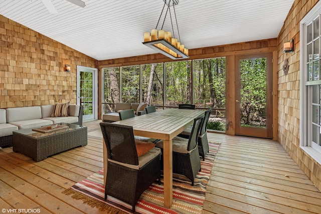 sunroom featuring an outdoor living space, a ceiling fan, lofted ceiling, and outdoor dining space