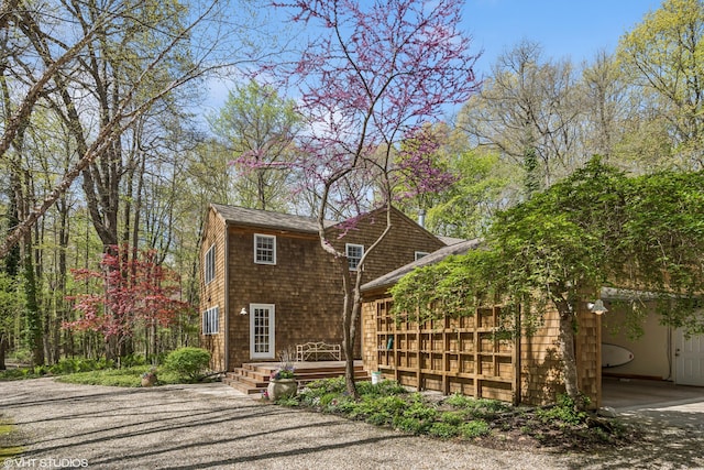 view of front of home featuring a wooden deck and driveway
