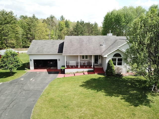 4930 Warrington Way, Gladwin, MI 48624 - view of front of property with a garage, asphalt driveway, roof with shingles, and a front yard