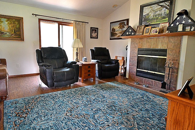 4930 Warrington Way, Gladwin, MI 48624 - living area with vaulted ceiling, wood finished floors, baseboards, and a tiled fireplace