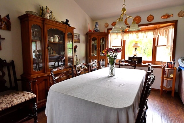 4930 Warrington Way, Gladwin, MI 48624 - dining area featuring dark wood finished floors, vaulted ceiling, and a chandelier