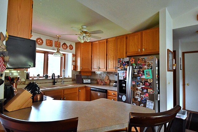 4930 Warrington Way, Gladwin, MI 48624 - kitchen with a sink, stainless steel appliances, a peninsula, a ceiling fan, and decorative light fixtures