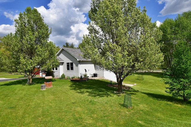 4930 Warrington Way, Gladwin, MI 48624 - view of side of property featuring a yard and roof with shingles