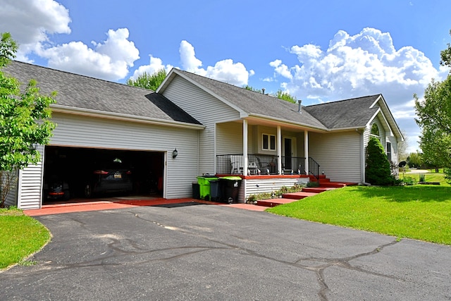4930 Warrington Way, Gladwin, MI 48624 - view of front facade featuring covered porch, a garage, a front yard, asphalt driveway, and a shingled roof