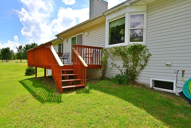 4930 Warrington Way, Gladwin, MI 48624 - view of home's exterior with a wooden deck, a chimney, and a lawn
