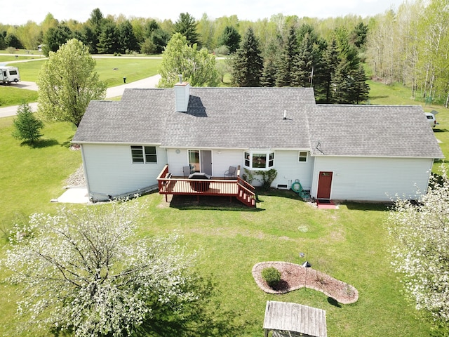4930 Warrington Way, Gladwin, MI 48624 - back of house featuring a wooden deck, a yard, roof with shingles, and a chimney