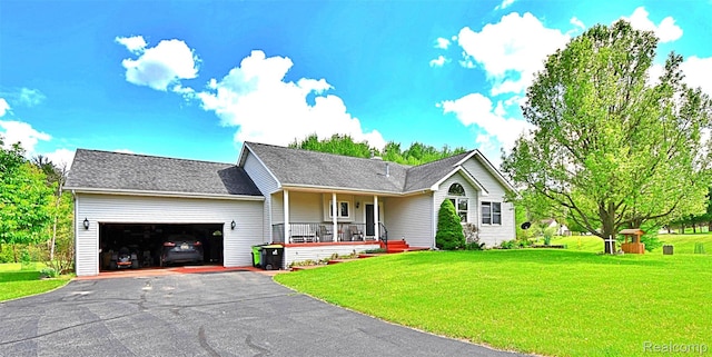 4930 Warrington Way, Gladwin, MI 48624 - ranch-style home with covered porch, a garage, a front lawn, and driveway