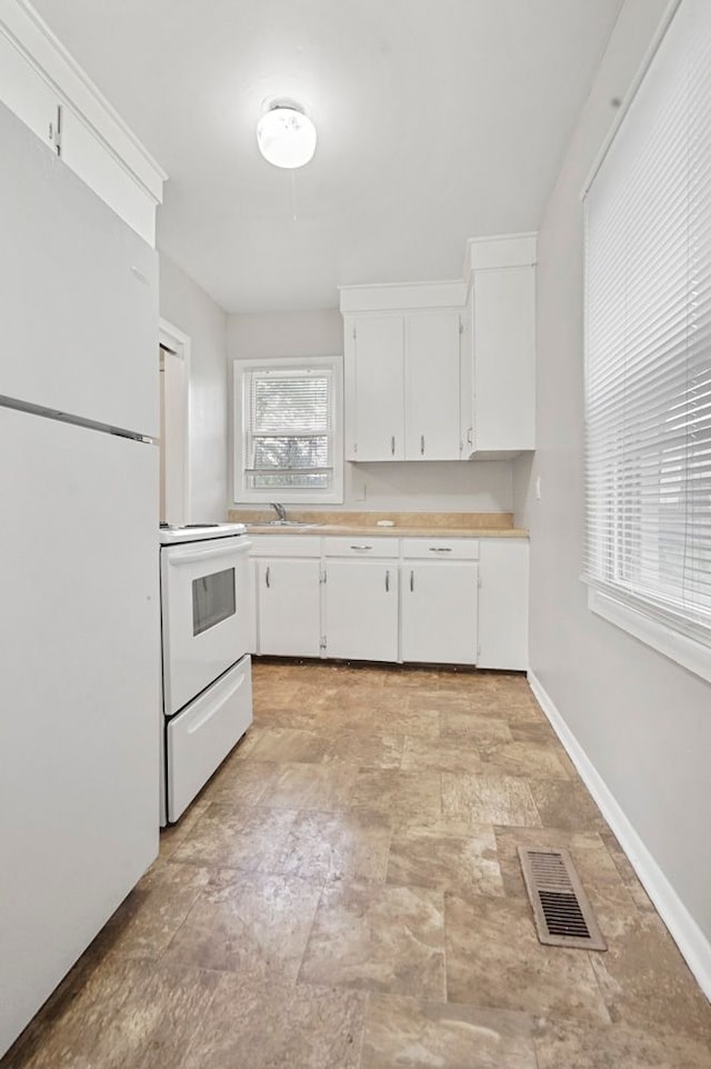 1631 Channing St, Ferndale, MI 48220 - kitchen with white appliances, light countertops, white cabinetry, and baseboards