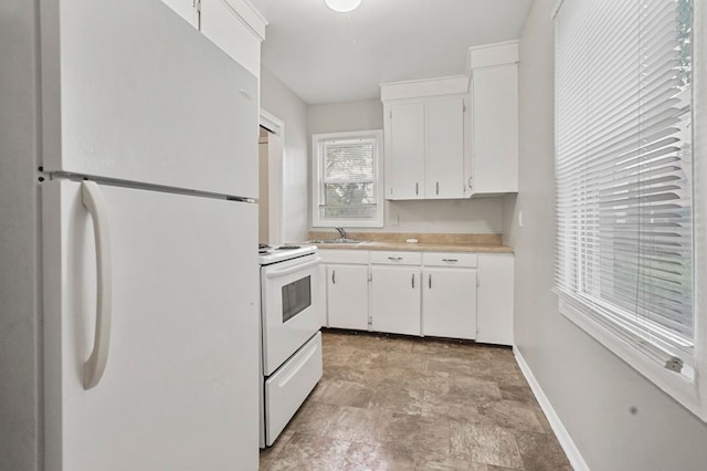 1631 Channing St, Ferndale, MI 48220 - kitchen with white appliances, white cabinetry, light countertops, and stone finish floors