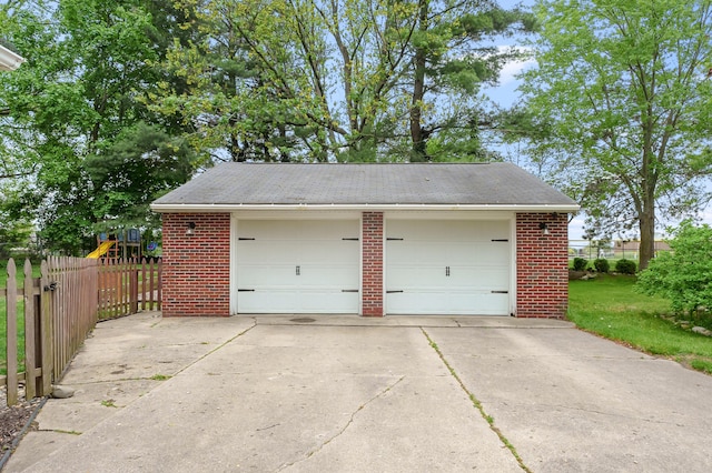 detached garage featuring fence