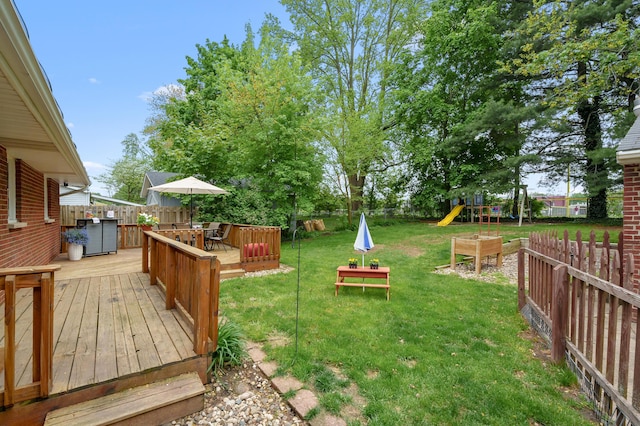 view of yard featuring a playground and a deck