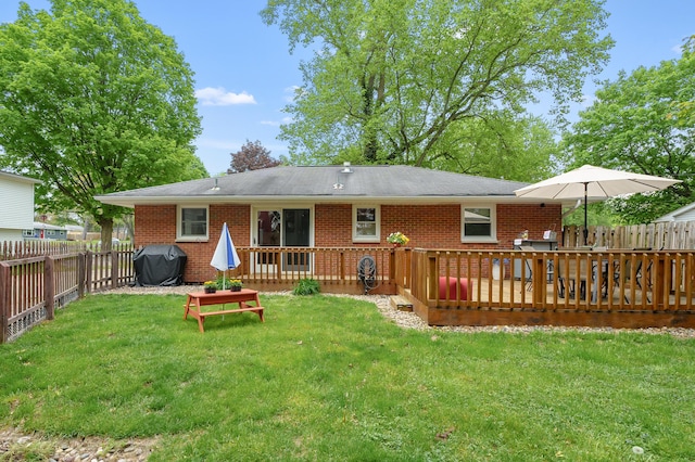 rear view of property with brick siding and a wooden deck