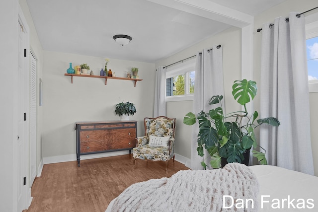 bedroom featuring wood finished floors and baseboards