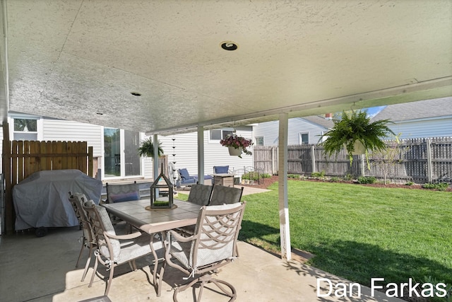 view of patio with a grill and outdoor dining area