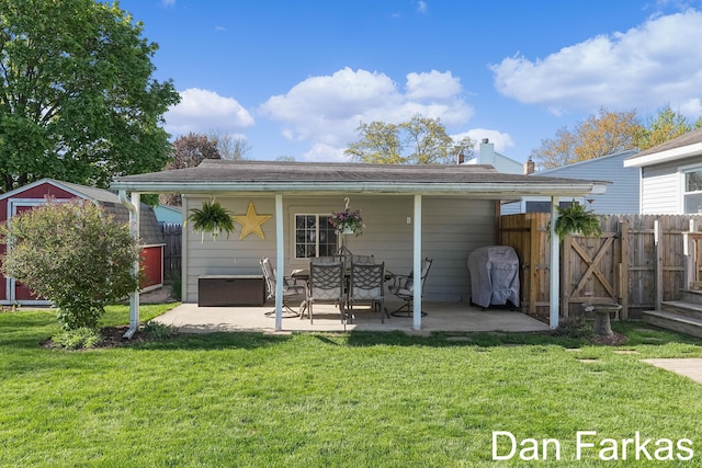 back of property featuring a patio area, a storage shed, and an outdoor structure