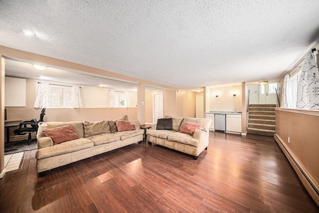 living area with baseboard heating, a textured ceiling, dark wood-type flooring, stairway, and baseboards