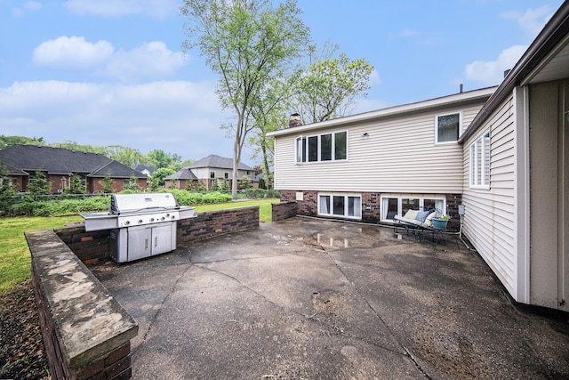 view of patio featuring grilling area and fence