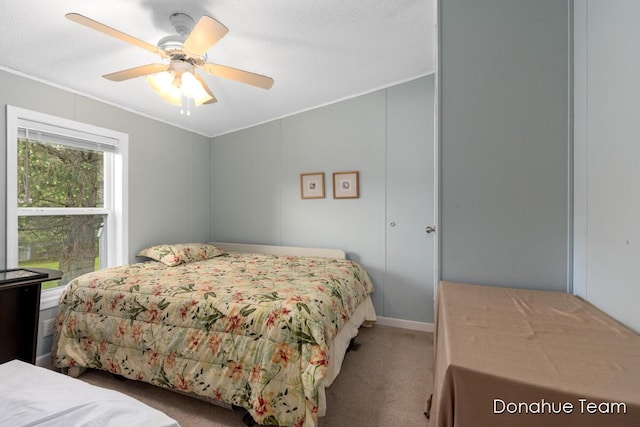bedroom with crown molding, carpet flooring, and ceiling fan